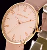 Close-up of a women's watch face with a pink dial and gold-colored casing and hands. Produktbild-Vorschau