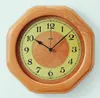 An octagonal wooden wall clock with a yellow face and black hands. Anteprima dell’immagine prodotto