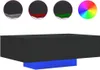 A 3D rendering of a black rectangular coffee table with a blue rectangular base, displayed alongside inset circular images showing color options. Produktbild-Vorschau