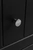 A close-up shot of a black cabinet with a silver knob. Náhled obrázku produktu