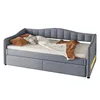 A gray upholstered daybed with pillows and a blanket. Náhled obrázku produktu