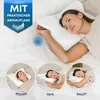 A woman is lying on a bed with a special pillow designed for arm support while sleeping. The image also includes smaller circular insets showing the pillow being used in different sleeping positions. Produktbild-Vorschau