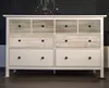 A white dresser with eight drawers against a black chalkboard background with white writing. Produktbild-Vorschau