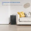A folded mattress is placed next to a sofa in a living room setting. Produktbild-Vorschau