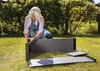 A woman is assembling a raised garden bed in a grassy yard. Náhľad obrázku produktu
