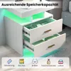 A white nightstand with two open drawers, illuminated by green LED lights, with icons and text at the bottom. Náhled obrázku produktu