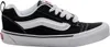 A side view of a black Vans sneaker with white laces and a white stripe. Voir les images du produit