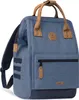 A blue rucksack with brown leather accents is shown against a white background. Voir les images du produit