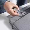 A person is holding a USB-C to USB-A adapter cable over a grey laptop sleeve. Podgląd zdjęcia produktu