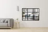 A modern living room with a grey sofa and a decorative window panel on the wall. Produktbild-Vorschau