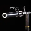 Close-up of a barbell sleeve with a spring collar attached, resting on a rack. Voir les images du produit