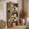 A tall, rustic brown bookshelf filled with books and decorative items, placed in a well-lit room with a textured wall and curtains. Anteprima dell’immagine prodotto