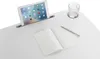 A white desk with a tablet, notebook, and glass of water. Anteprima dell’immagine prodotto