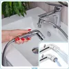 A hand holding a bidet sprayer attachment connected to a faucet in a sink. Anteprima dell’immagine prodotto