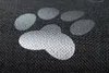 A close-up of a dark gray fabric with a white paw print pattern. Produktbild-Vorschau