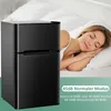 A woman sleeping in bed next to a mini refrigerator. Podgląd zdjęcia produktu