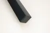 A close-up shot of the bottom corner of a black furniture leg against a white background. Voir les images du produit