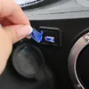 A hand is shown opening a blue protective cover over a USB port on a black electronic device. Produktbild-Vorschau