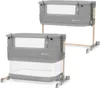 Two identical baby cribs are shown side-by-side against a white background. The cribs are gray with wooden legs and have mesh windows. Anteprima dell’immagine prodotto
