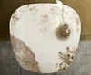 A top-down view of a marble-top coffee table with a vase of white flowers. Produktbild-Vorschau