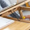 A close-up of a person using a portable laptop table. Produktbild-Vorschau