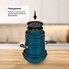 A stack of teal cookware with a black lid on a wooden surface, with a blurred kitchen background. Produktbild-Vorschau