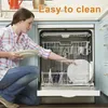 A woman is loading dishes into a dishwasher. Produktbild-Vorschau