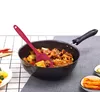 A silicone spatula is shown in a cooking pan filled with food, with side dishes in bowls. Produktbild-Vorschau