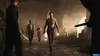A group of men in vintage clothing are in a dimly lit, cavernous space, possibly a warehouse or cellar. One man in the foreground is walking towards the viewer, holding a knife. The scene appears to be from a video game. Produktbild-Vorschau