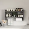 A kitchen shelf with various jars, mugs, and a paper towel holder. Anteprima dell’immagine prodotto