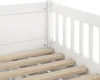 A close-up view of the corner of a white wooden bed frame, showing the slatted base and the railing. Produktbild-Vorschau