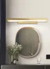 A bathroom vanity with a mirror, a light fixture above it, and decorative items. Produktbild-Vorschau