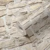 A roll of wallpaper with a stone pattern is shown. Produktbild-Vorschau