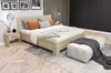 A bedroom scene with a bed, nightstand, and decorative items. Voir les images du produit