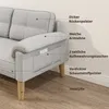 A close-up view of the armrest and side of a gray sofa, with labels pointing out its features. Produktbild-Vorschau