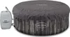 A round, inflatable hot tub with a gray cover and a wood-grain patterned base, connected to a control unit. Produktbild-Vorschau