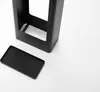 A black metal umbrella stand with a removable tray is shown on a white background. Produktbild-Vorschau