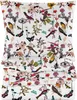 A stack of folded bedding with a floral and bird pattern. Produktbild-Vorschau