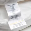 A close-up of a product label with material composition and certification information. Produktbild-Vorschau