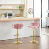 Two pink bar stools with gold legs are placed in a kitchen setting. Produktbild-Vorschau