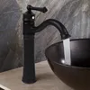 A black faucet with water running into a dark basin. Náhled obrázku produktu