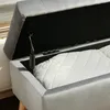 Close-up view of an open storage bench with a white quilted cushion inside. Náhled obrázku produktu