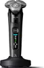 A black electric shaver with a silver shaving head sits on a black charging stand against a white background. Náhled obrázku produktu