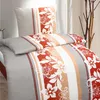 A neatly made bed with a floral patterned duvet cover and pillow. Produktbild-Vorschau