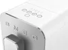 A close-up view of the top and front of a white SMEG coffee machine, showing the brand name and control buttons. Voir les images du produit