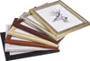A stack of picture frames of various colors and finishes, with one frame containing a drawing of a deer. Produktbild-Vorschau