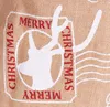 A close-up of a burlap Christmas sack with a reindeer and festive text. Podgląd zdjęcia produktu