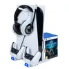 A white Playstation 5 Slim charging station with headphones, two controllers, and a game case. Podgląd zdjęcia produktu