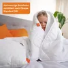 A young girl is wrapped in a white blanket on a bed, smiling. Náhled obrázku produktu