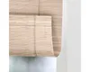 A close-up view of a natural bamboo roller blind. Náhled obrázku produktu